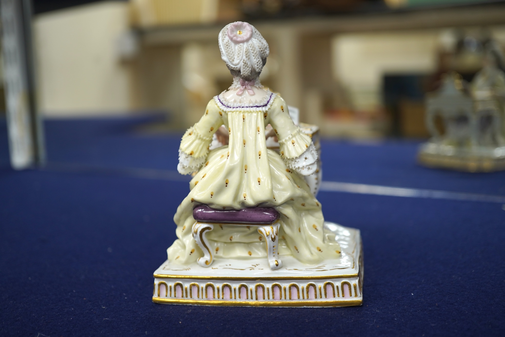A pair of 19th century Meissen figures of a girl holding a shell and a boy holding a book, in size model number 628, tallest 13cm